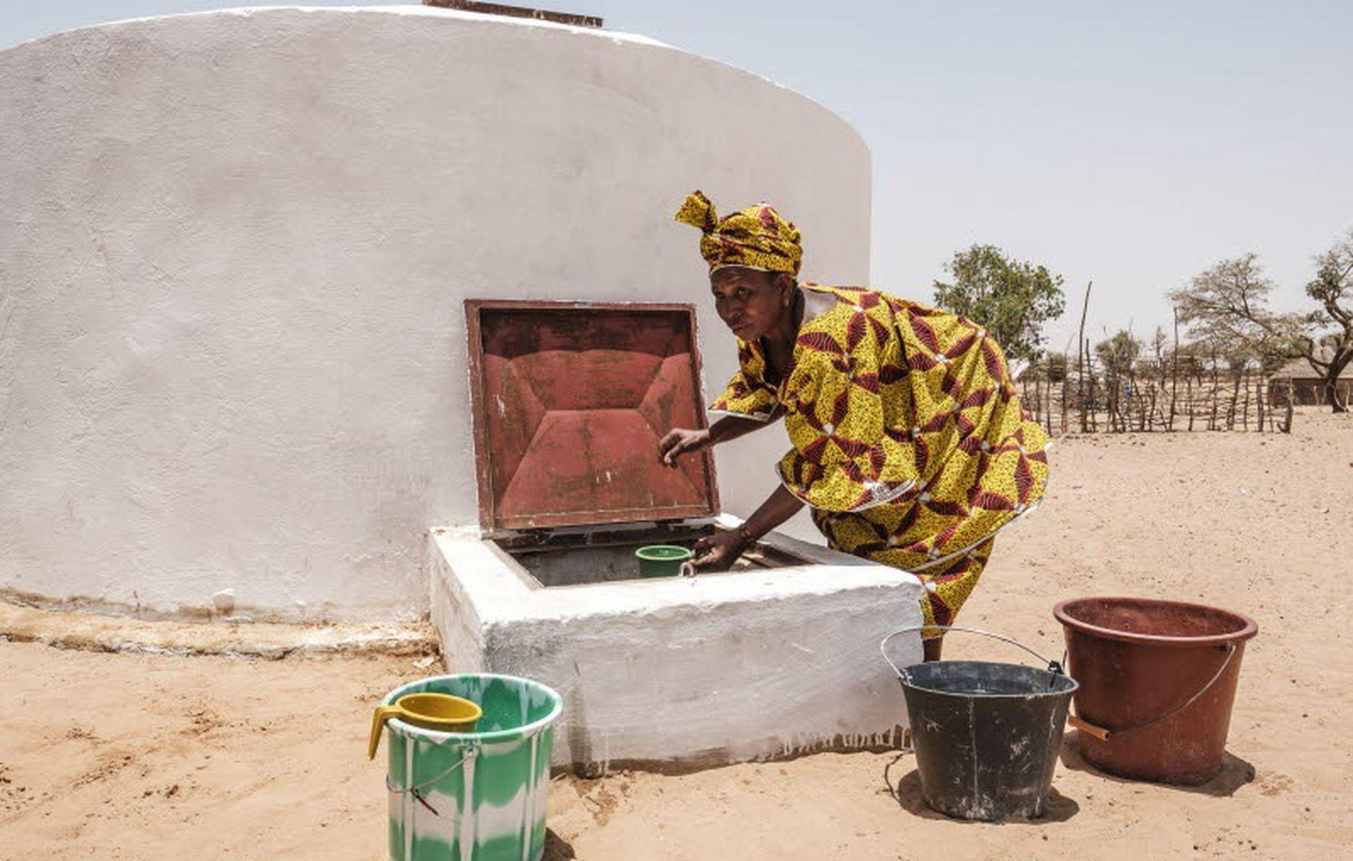26 April 2019, village of Douly, near Touba, Senegal - Mboya Ka, beneficiary of the installation of a cistern, collecting water from a cistern in the village of Douly. The village is part of the initiative