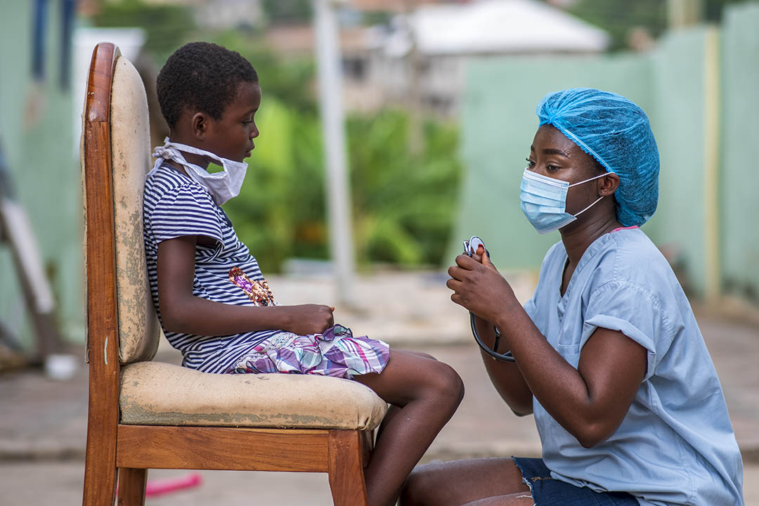 An African-American boy getting a checkup by a doctor